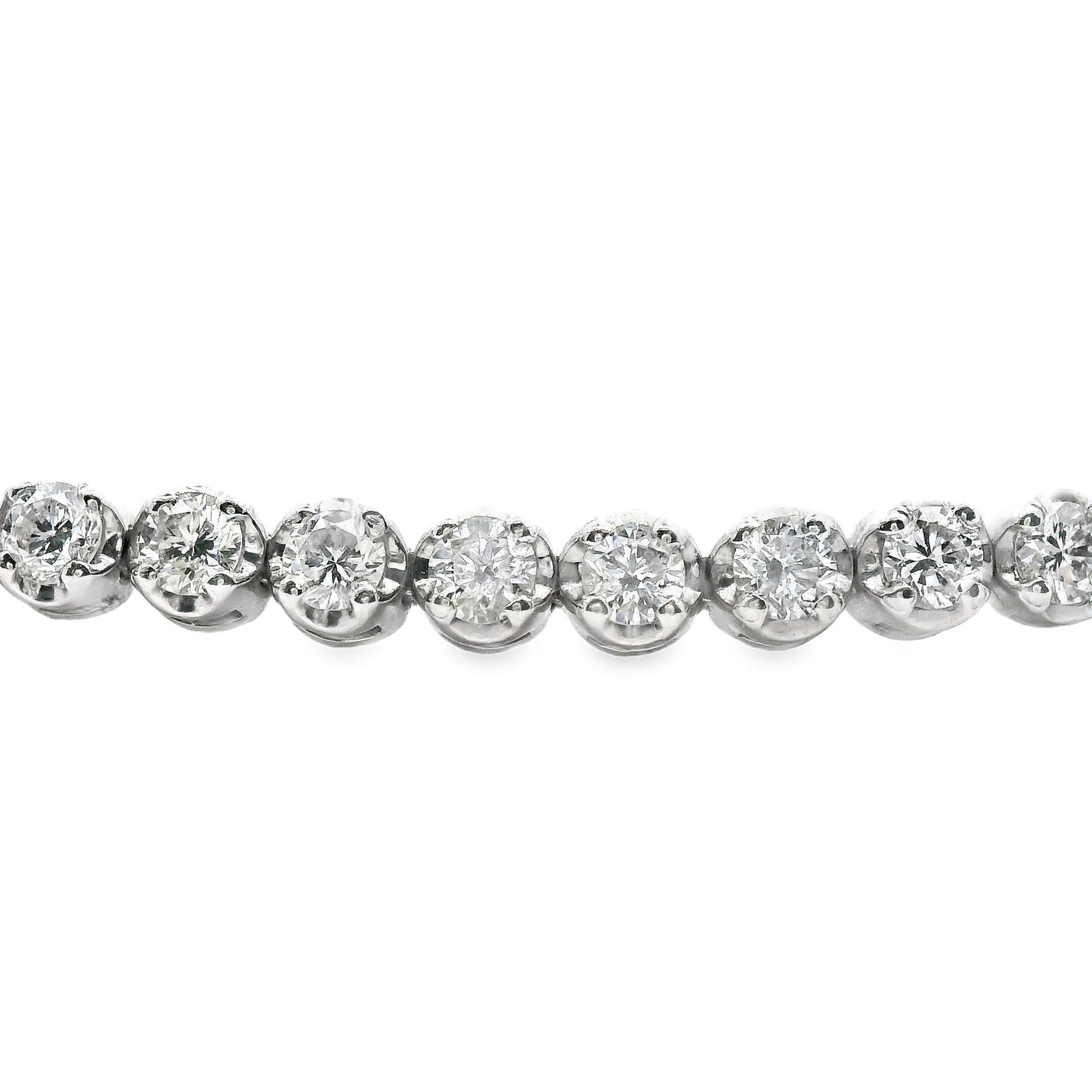 Close-up of the brilliant diamonds in the 14K white gold tennis bracelet, capturing their sparkle and beauty in a refined, luxury setting
