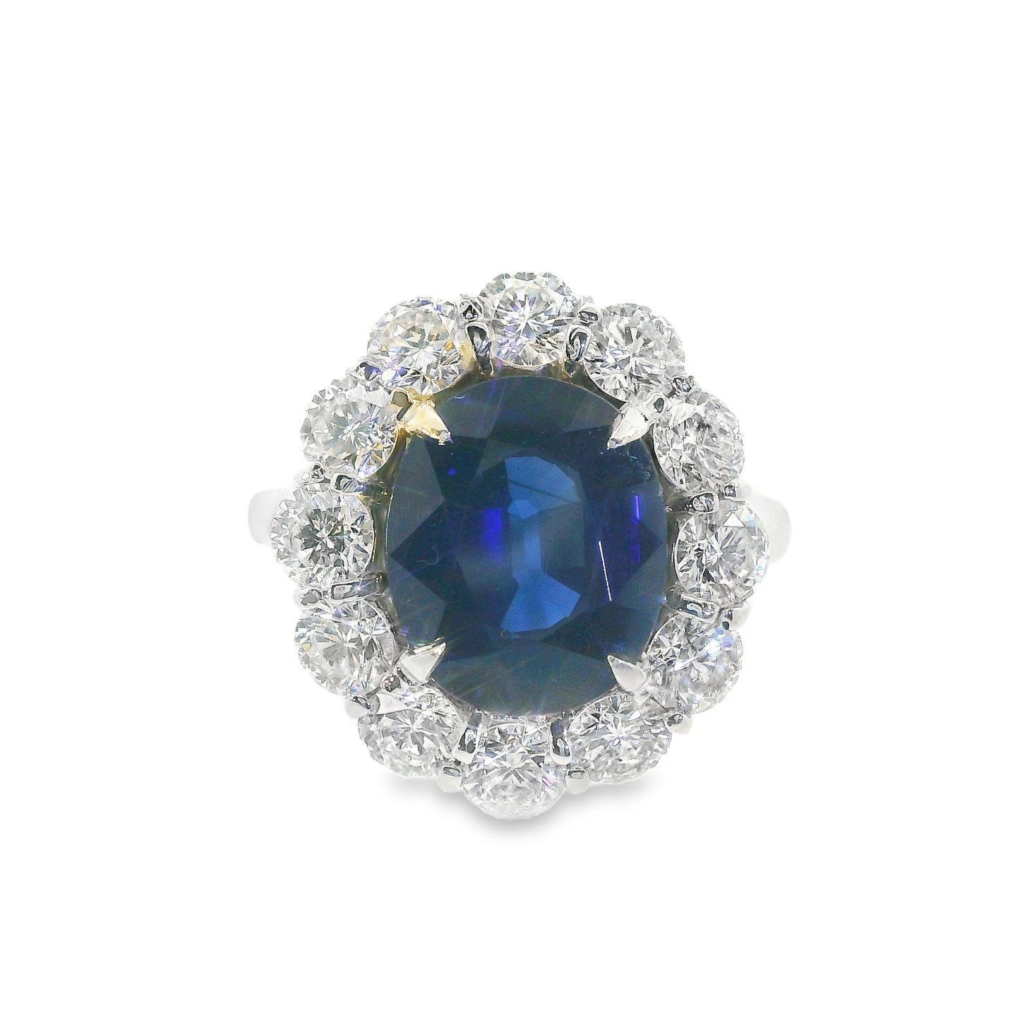 Front view of a stunning 14K white gold contemporary Lady Di ring featuring a vibrant blue sapphire center stone surrounded by sparkling diamonds.