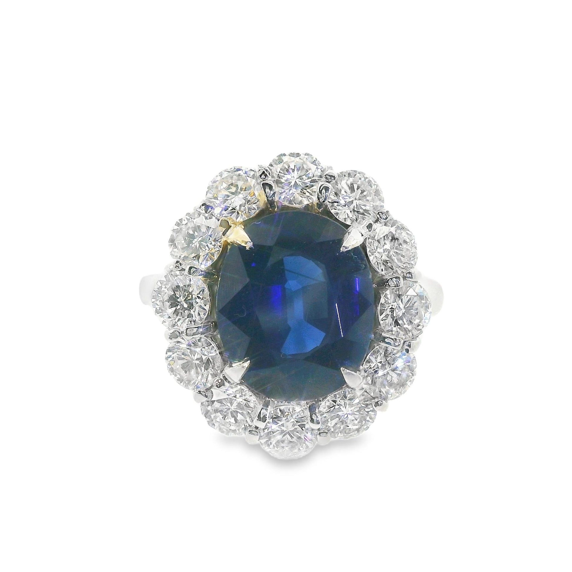 Front view of a stunning 14K white gold contemporary Lady Di ring featuring a vibrant blue sapphire center stone surrounded by sparkling diamonds.