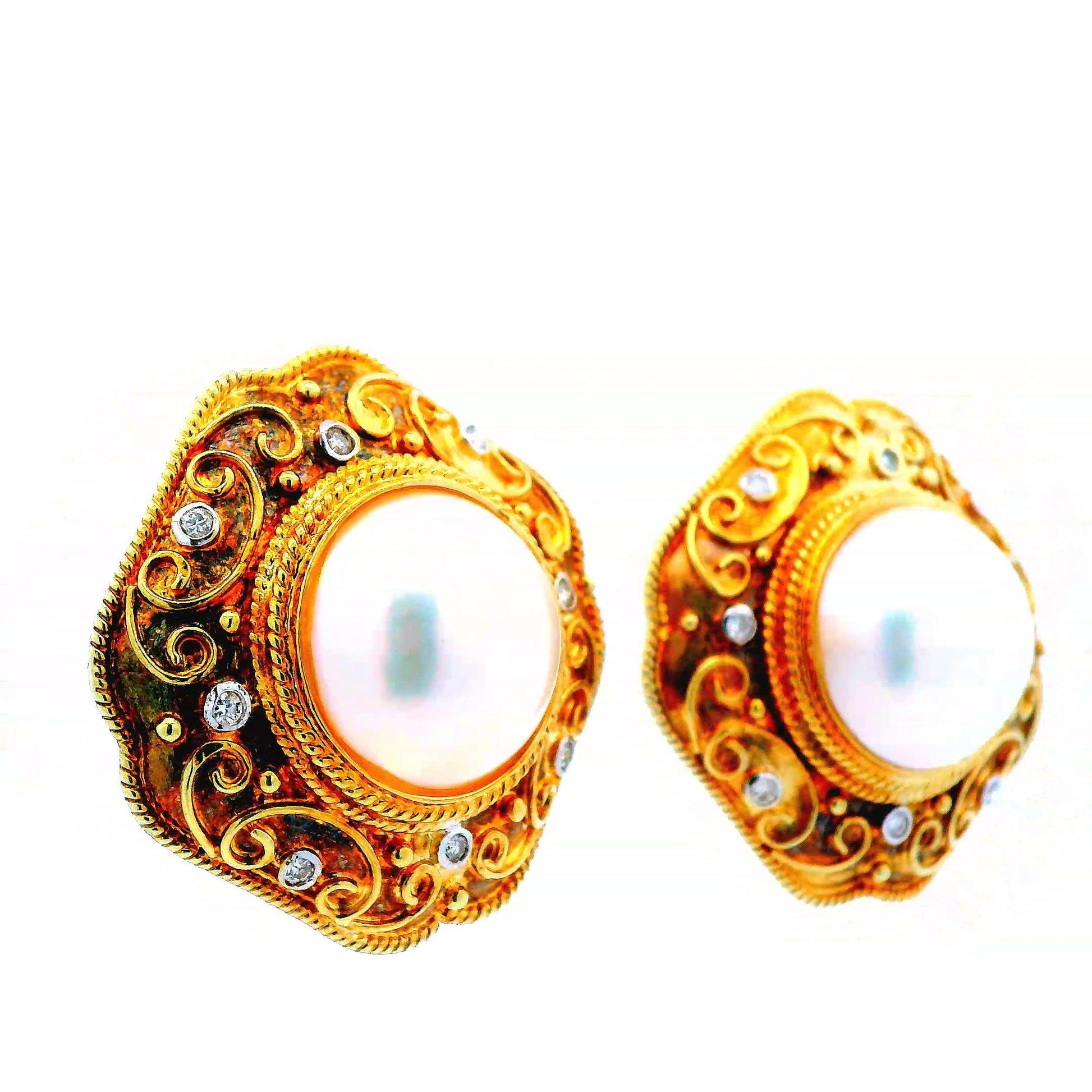 Side view of the 14K yellow gold Mabe pearl earrings, with diamonds encircling the 14.5mm pearls, highlighting their elegant and timeless design.