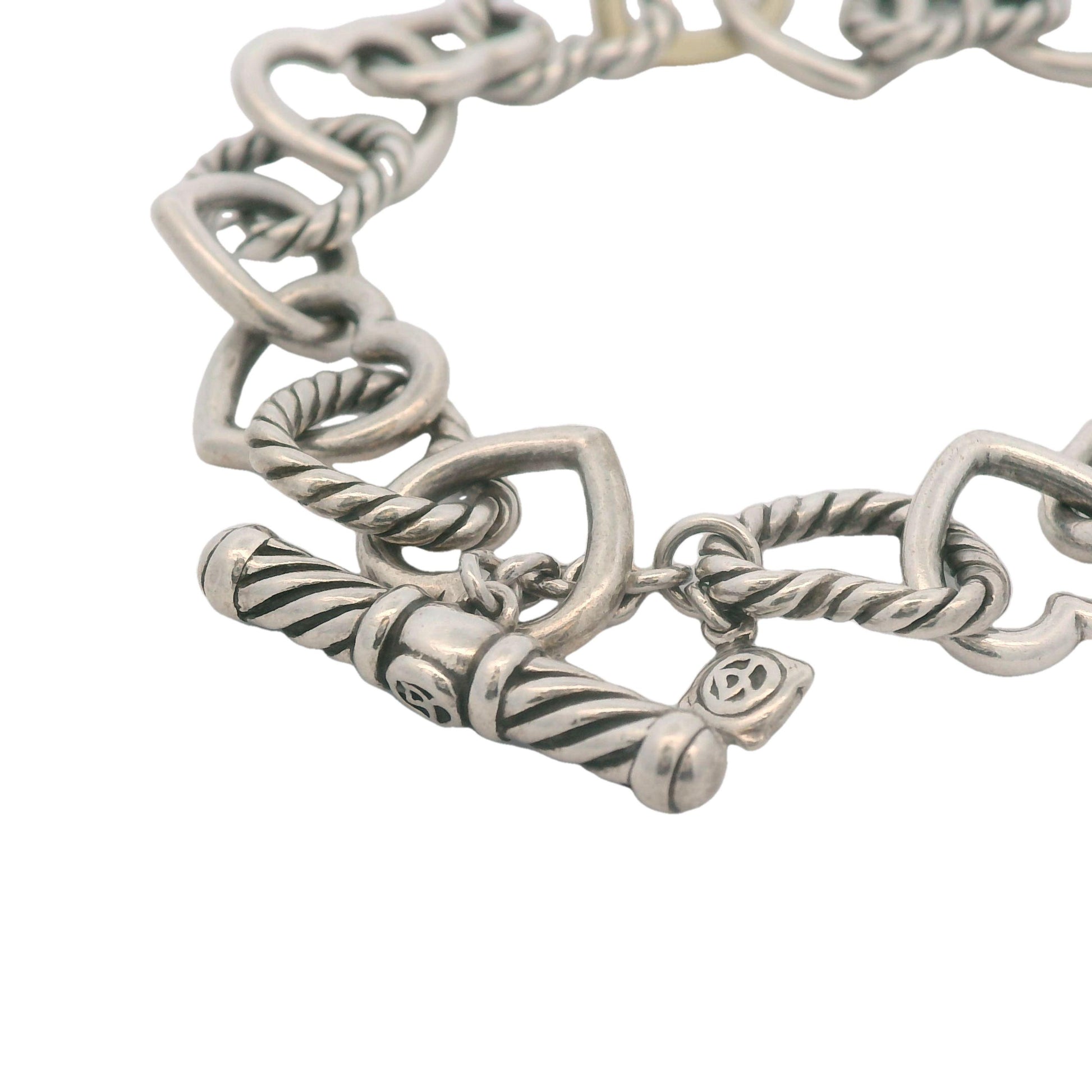 Close-up of the heart-shaped toggle clasp on David Yurman bracelet with sterling silver and 750 18K gold accents.