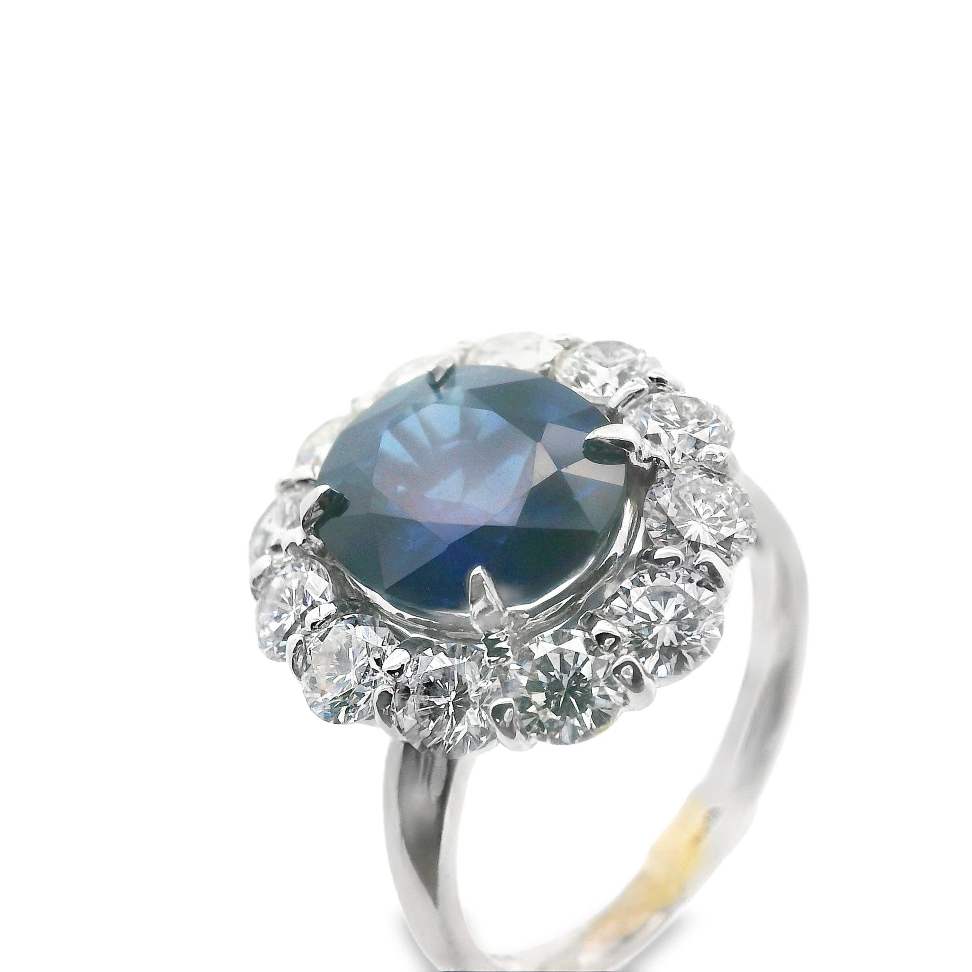 Top-down view of the 14K white gold Lady Di ring with blue sapphire center stone and diamond halo, showcasing its stunning symmetry and craftsmanship